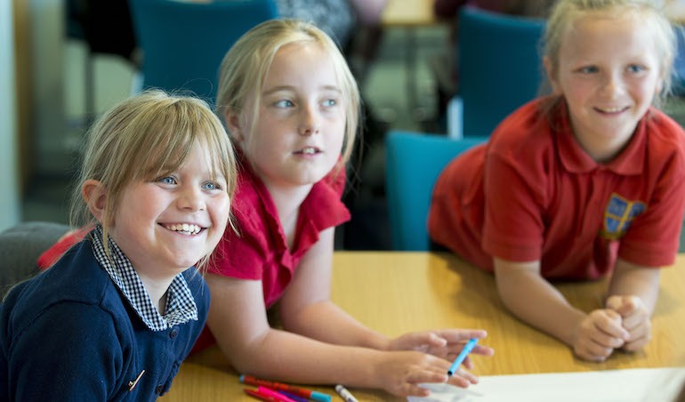 three primary pupils taking part in an ambassador scheme