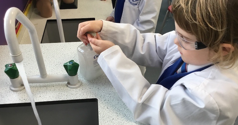 A pupil washes their hands before leaving the Phiz Lab and returning to their classroom