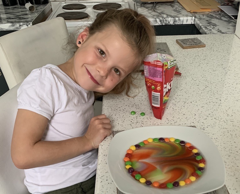 A girl shows off her colour investigation using sweets