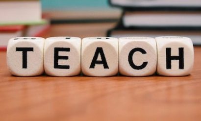 Five 'dice' spelling out the word TEACH