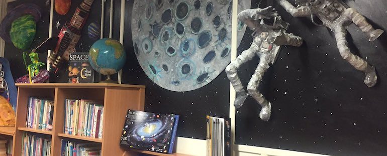 classroom displays featuring book shelves and astronauts