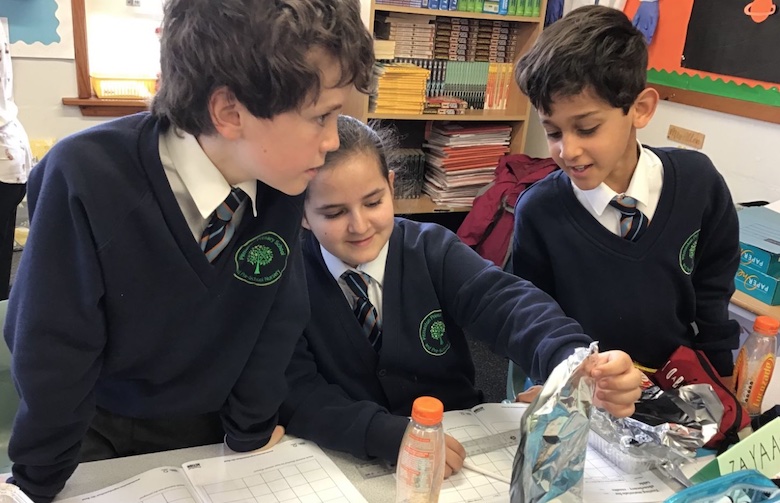 three children working together on a science project
