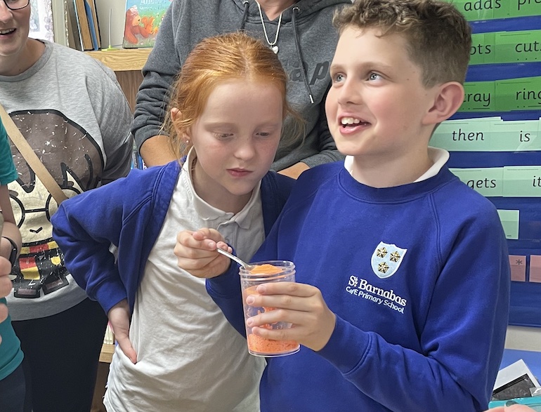 boy and girl looking at a science experiment