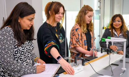 four female teachers taking part in a physics practical for their SKPT CPD session